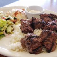 Beef Kabab Plate · 2 skewers of grilled marinated beef cubes served with rice, hummus, salad tahini sauce, and ...