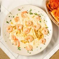 Fettuccine Alfredo · Homemade fettuccine in a fresh grated parmesan and cream sauce.  SERVED WITH GARLIC BREAD AN...