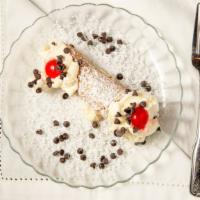 Cannoli (A Sicilian Tradition) · Delicate pastry shell filled with ricotta cream and chocolate chips.