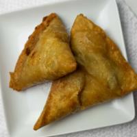 Vegetable Samosas · 2 per order. Triangular patties stuffed with potatoes and green peas and nuts