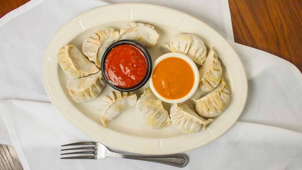 Chicken Momo · Minced chicken with onion, garlic and Himalayan spices wrapped in dough and steamed.