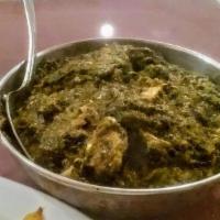 Saag Paneer · Seasoned pureed spinach leaves cooked with paneer.
