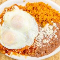 Chilaquiles · Fried tortilla chips with red or green salsa, two eggs over medium topped with queso fresco....