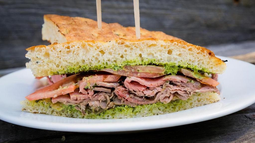 Gaucho Steak Sandwich · 100% grass-fed natural tri-tip, sliced tomato, grilled onions, and housemade chimichurri.