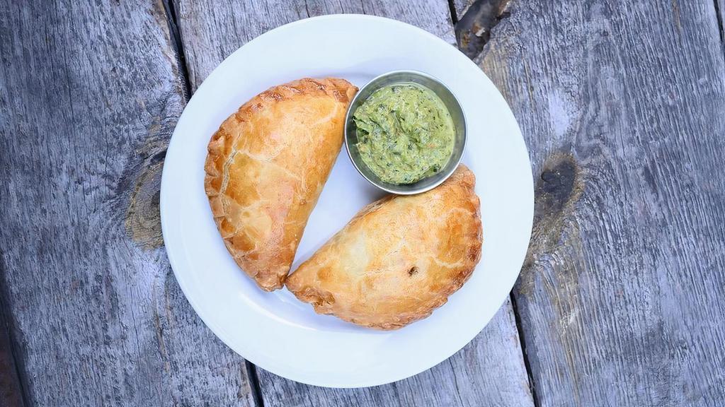 Veggie Empanada (V) · Yummy blend of spinach, roasted corn, bell peppers, potato, cilantro, onions and pepper-jack cheese. We recommend our fresh house made chimichurri as a dip.