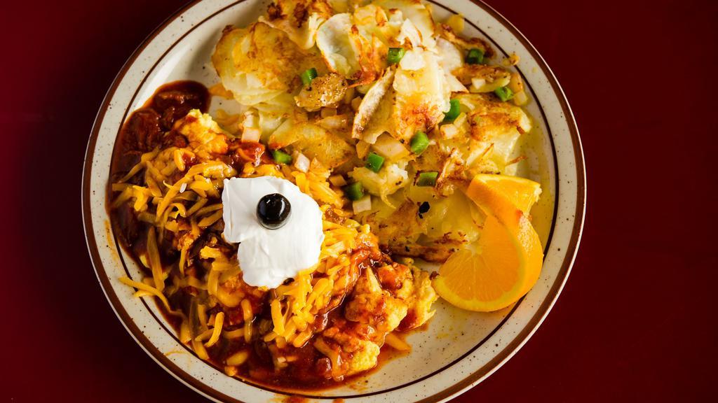 Enchilada Omelette · Shredded beef, onions, bell peppers and enchilada sauce with Jack & Cheddar cheese. Garnished with sour cream.