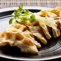 Gyoza · Pan fried pork and vegetable dumpling.