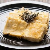 Agedashi Tofu · Lightly fried tofu with tempura sauce on the side.