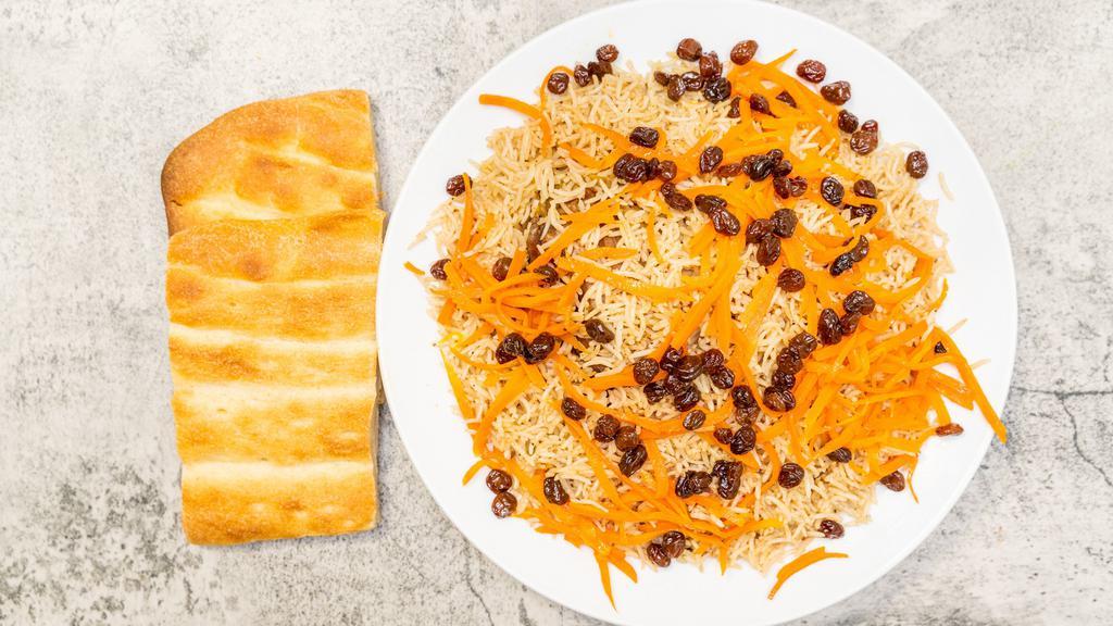 Qabili Palaw · Rice with lamb shank, delightfully seasoned, topped with raisins and carrots and Afghani bread.