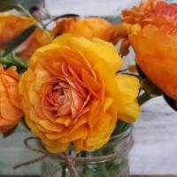 Seasonal Orange Floral Bouquet · All our flowers are grown on our farm, this bouquet consists of orange ranunculus, eucalyptu...