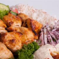 Chicken Rabob · Skinless marinated chicken breast skewer, served with hummus, rice, salad, pickles, roasted ...