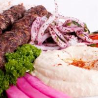 Kafta Kabob · Skewer of ground beef kneaded with chopped parsley, onions and spices, served with hummus, r...
