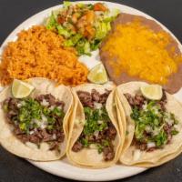 Street Tacos · Three tacos on soft corn tortillas with cilantro, onion, lime, served with pico de gallo, ri...