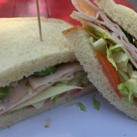 A.C. · Smoked Turkey, Bacon, Sliced Avocado, Tomato, Lettuce, Swiss Cheese, and Spiced Mayo on Sour...