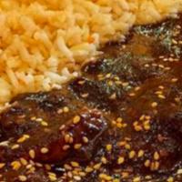 Mole Oaxaqueno De Pollo · Chicken Breast served with mole sauce (chocolate, chili pepper, nuts and spices) , rice, bea...