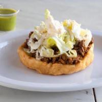 Sopes · A thick Corn shell, with a layer of refried beans, choice of protein, lettece, sour cream an...