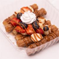 Fruity Churros · 3 chopped churros covered in a cinnamon sugar, topped with mixed berries (strawberries, blue...