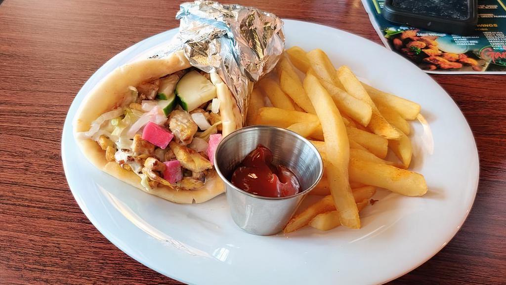 Chicken Shawarma Wrap · Hummus paste, tomatoes, onions, shredded lettuce, turnip pickles, drizzled with white and tahini sauce.