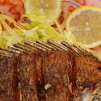 Fried Whole Tilapia/ Mojarra · fried mojarra served with rice, beans and tortillas