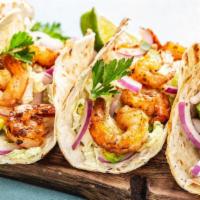 Shrimp Soft Taco · Crispy golden shrimp, cabbage, pico de gallo, and cream, served on a warm tortilla.