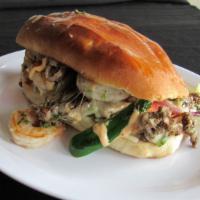 Cancun Torta · Shrimps and steak with melted cheese, grilled onions, jalapeno, and special sauce. Comes wit...
