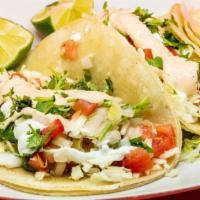 2 Baja Style Fish Tacos · Beer Battered Tilapia fish topped with fresh cabbage diced tomatoes drizzled with our house ...