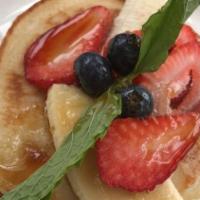 Gluten-Free Pancakes · Topped w/ mixed berries, banana, organic maple syrup.