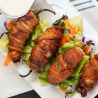 Bacon Wrapped Jalapeños · Fresh jalapeños stuffed with cream cheese and wrapped in bacon.