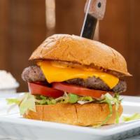 Pub Burger · Homemade beef patty grilled and topped with tomatoes, lettuce, Pub’s secret sauce on a brioc...