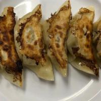 Gyoza · Homemade pan-fried potstickers stuffed with ground pork and cabbage.