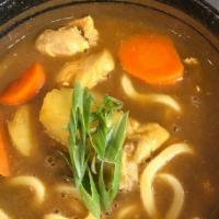 Curry Udon · Topped with pieces chicken, carrot and potato.