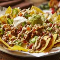 Tex-Mex Nachos · Tortilla chips layered with cheese, chili topped with shredded lettuce, pico de gallo, fresh...