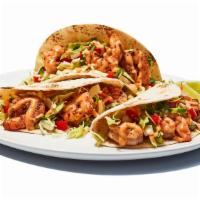 Baja Shrimp Tacos · Grilled blackened shrimp, served on soft tortillas with pico de gallo, cabbage, and house sp...