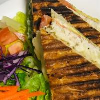 Panini Sandwich · Grilled sandwich with melted swiss cheese, caramelized onions, sliced tomatoes, avocado, & m...