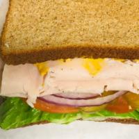 Turkey Sandwich · Turkey with lettuce, tomato, onion and pickles.  Mayo and mustard on your choice of bread.