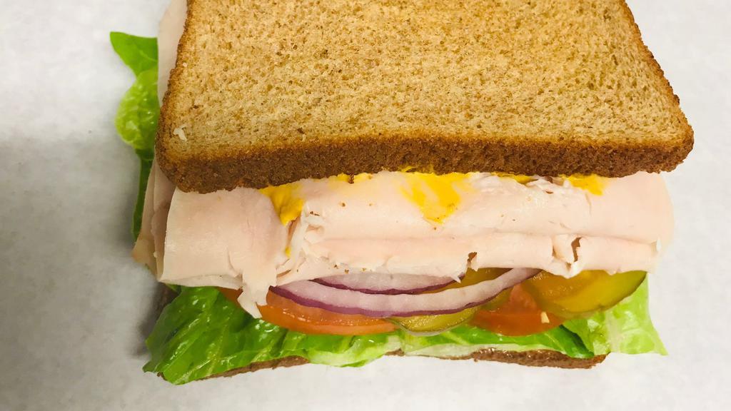 Turkey Sandwich · Turkey with lettuce, tomato, onion and pickles.  Mayo and mustard on your choice of bread.
