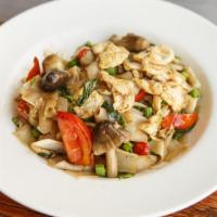 Drunken Noodle · Stir-fried noodles with choice of meat, green bean, basik, onion, tomato, and bell pepper.