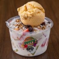 Escamocha · Diced fruit in a bowl with homemade sweet cream topped with granola, raisins, and shredded c...