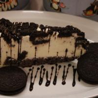 Oreo Mousse  Cake Slice  · Oreo Mousse  cheesecake slice with the drizzle of chocolate sauce on top