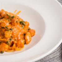 Spaghetti Portofino · Spaghetti with shrimp and capers in a light cream tomato and cognac sauce.