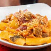 Paccheri E Salsiccia · Giant rigatoni, pork sausage, roasted sweet red onions, oven-roasted tomatoes, parmigiano re...