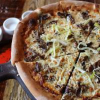 Pizza Della Terra · Wild mushrooms, braised leeks, taleggio, truffle oil.