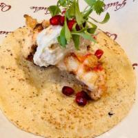Lobster En Nogada · Garlic chipotle butter poached lobster tail, walnut cream sauce, pomegranate, garnished with...