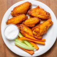 Queens Chicken Wings · Tossed in classic buffalo hot sauce or BBQ sauce served with a side of ranch or blue cheese ...