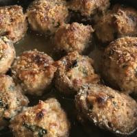 Baked Stuffed Mushrooms · A skillet full of caps stuffed with pancetta, spinach, onion, ricotta, and mozzarella; toppe...