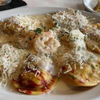 Lobster Ravioli & Spicy Shrimp · Ravioli stuffed with tender cold water lobster. Served in a spicy tomato sauce with jumbo sh...