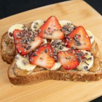 Almond Butter Toast · Almond butter on multi grain bread, banana, strawberry, cacao nibs and honey.