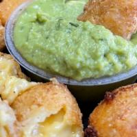 Mac N Cheese Bites · 12 Mac and Cheese bites served with a side of Guacamole