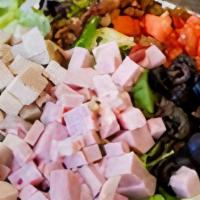 Cobb Salad · This salad is more like a meal.  Mixed lettuce topped with chunks of ham and turkey, black o...