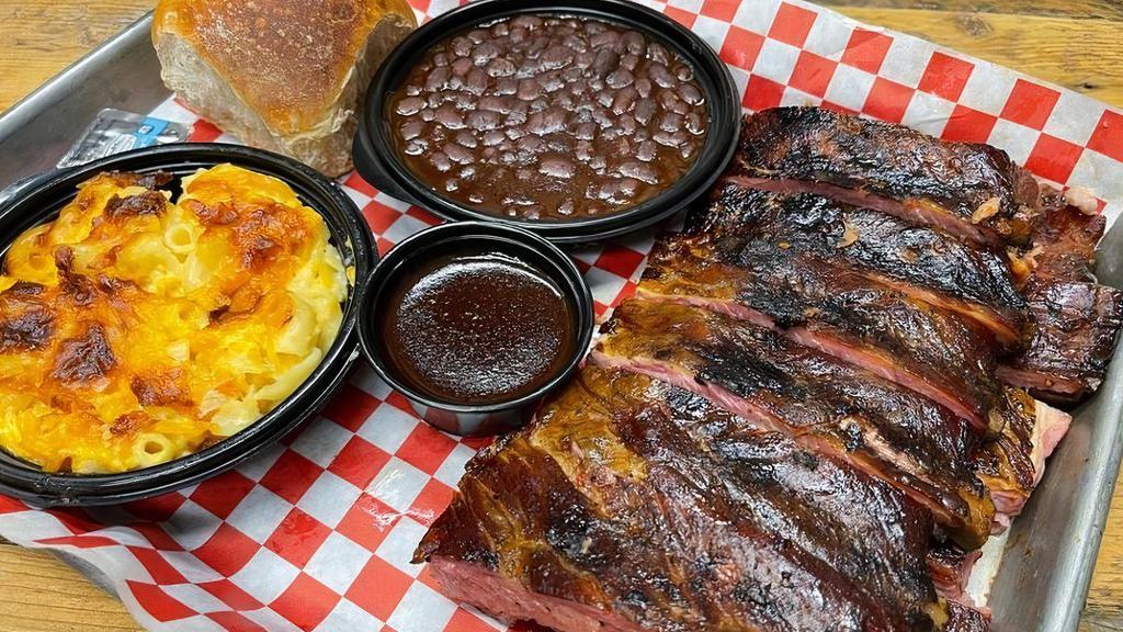 1/2 Slab · Our ribs are slow smoked and tender.  This half slab will satisfy any craving.  Includes two sides of your choice and a dinner roll.